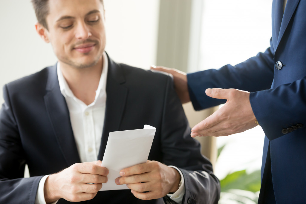 employee being handed a paycheck