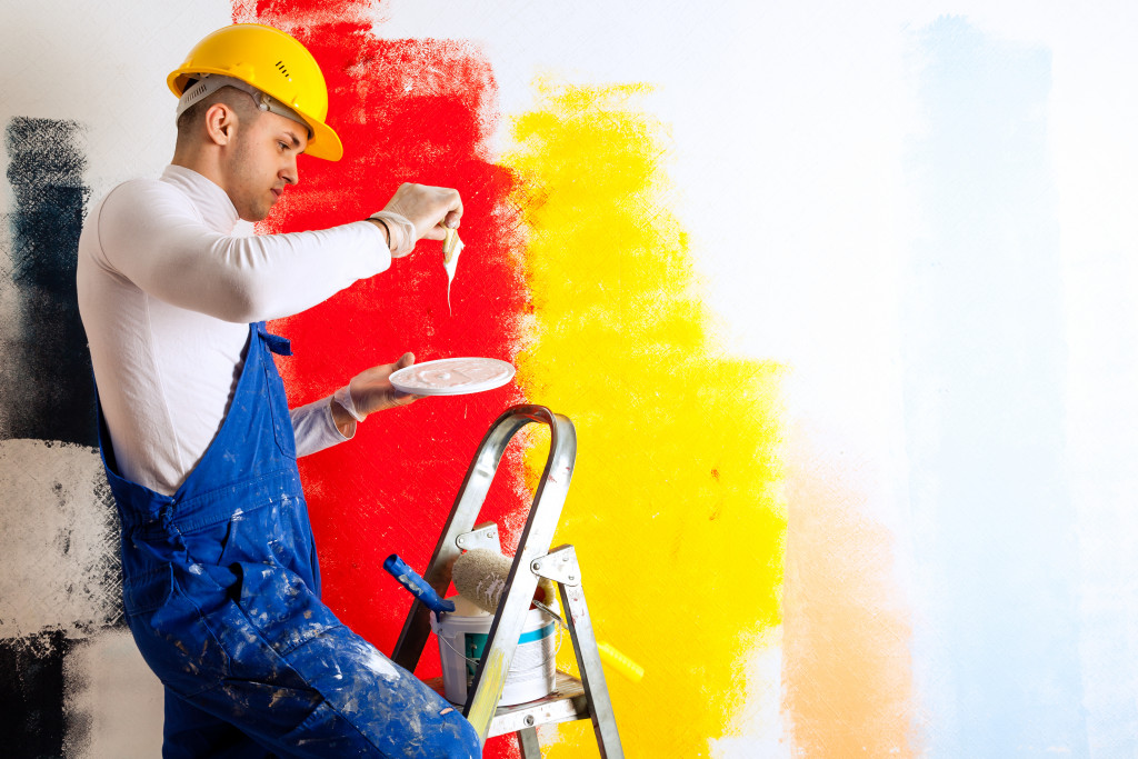 man painting a wall