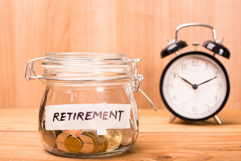 A retirement savings jar with a clock in the background