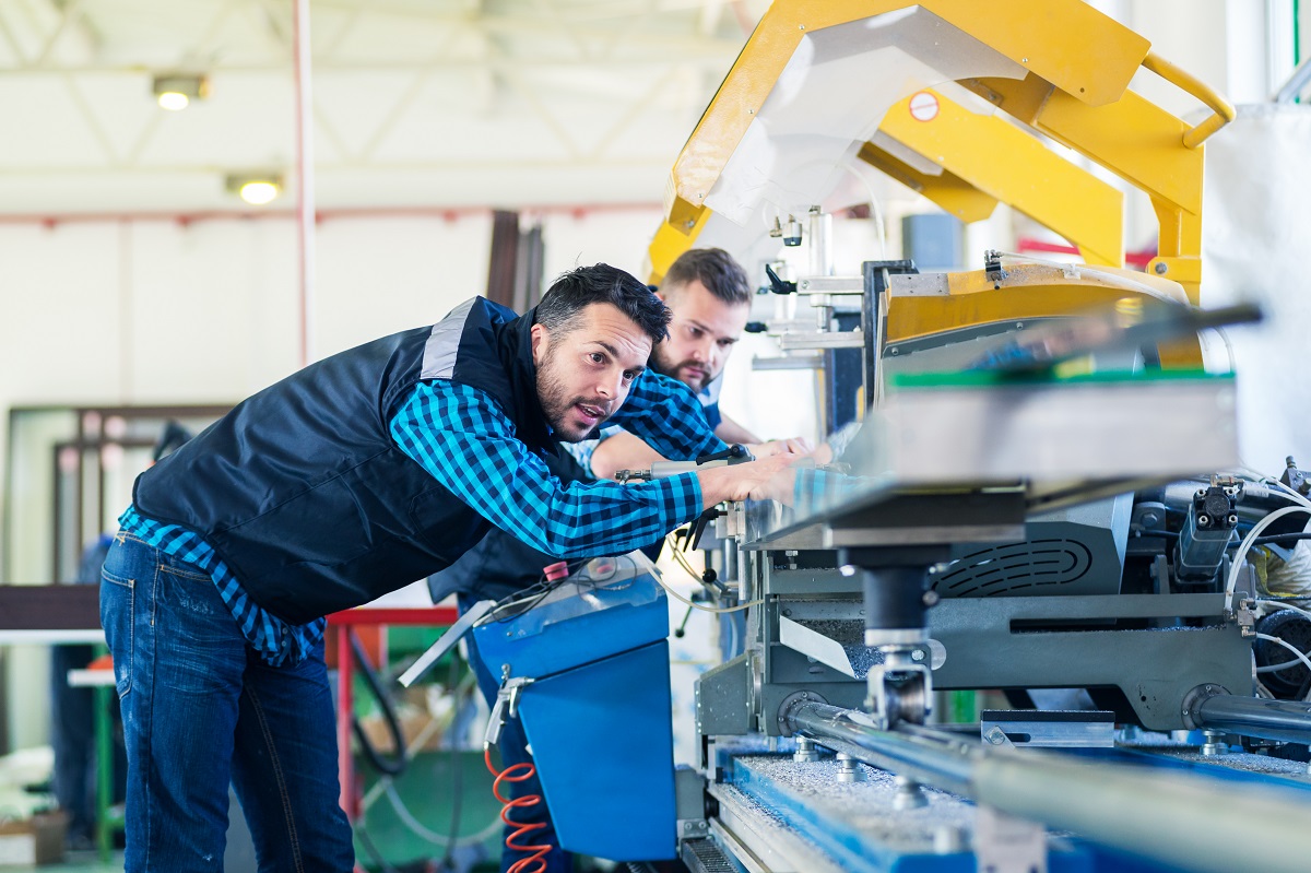 manufacturing workers checking the machinery equipment